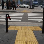 BRAD DOWNEY out in the streets the workshop group 're-designed' the city with the most simple means like a roll of red tape~~